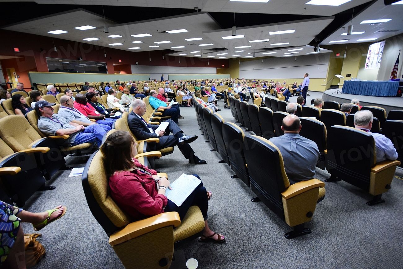 Delegates seated in a raked conference auditorium